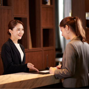 A lady checks into a hotel