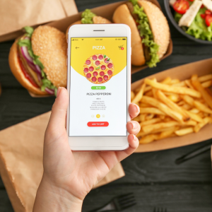 Someone ordering takeaway pizza on mobile phone app